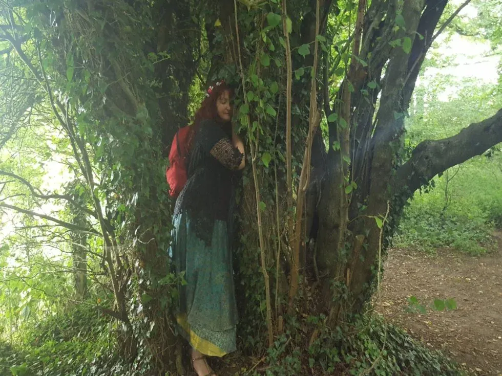 Raquel G. Eireen junto a un árbol